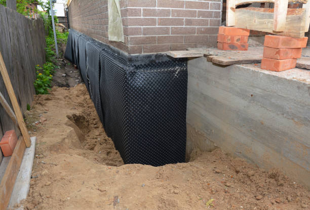 Happy homeowners after waterproofing job in Ramer